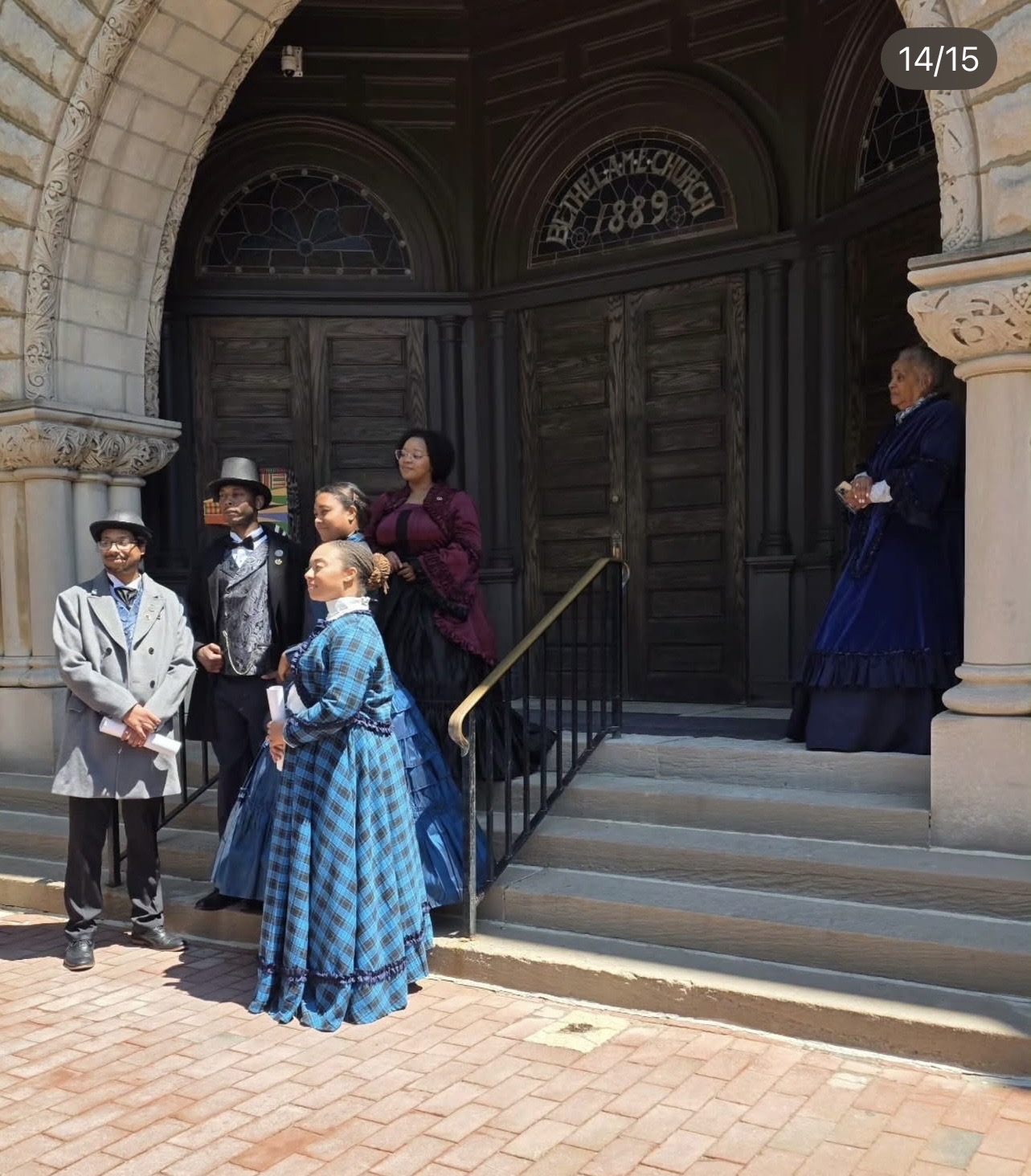 Reenactors in 1860s dress on the steps of Bethel A.M.E. Church